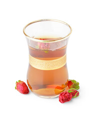 Glass cup of Turkish tea with roses on white background