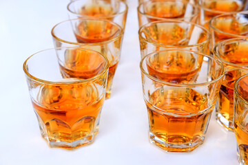 whiskey brandy alcohol is poured into glasses on the table a lot of glasses with booze
