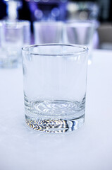 a transparent glass stands on a white tablecloth on a buffet table celebration breaking a ban on drinking alcohol