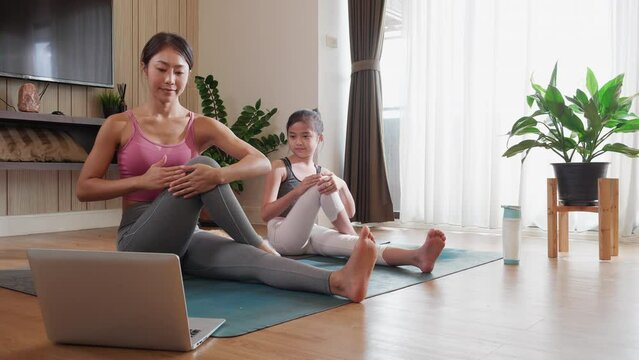 Asian Woman And Daughter Connect Virtually For Yoga Online Course, Promoting Healthy Lifestyle