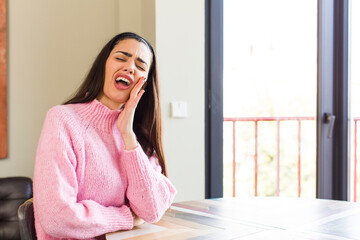 pretty caucasian woman feeling shocked and astonished holding face to hand in disbelief with mouth wide open