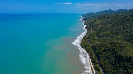 aerial view of a road on the shore of the blue sea