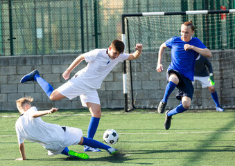 Obraz premium Youth football player kicking ball in direction of goal