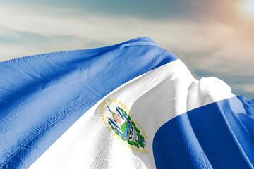 El Salvador national flag cloth fabric waving on beautiful grey sky.