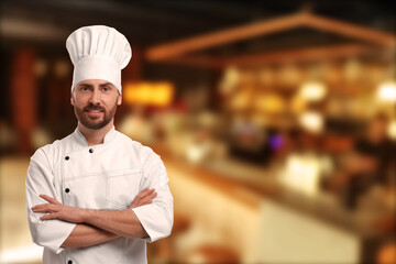 Smiling chef in uniform at restaurant, space for text