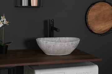 Stylish laundry room with grey marble sink. Interior design