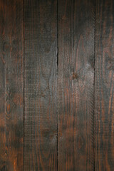 Texture of dark brown wooden surface as background, closeup