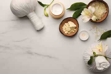 Obraz na płótnie Canvas Flat lay composition with spa products and flowers on white marble table. Space for text