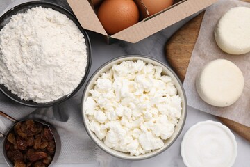 Different ingredients on white marble table, flat lay. Cooking cottage cheese pancakes