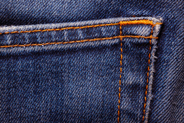 Worn denim trousers. Machine stitch close up. Denim texture in blue. The concept of repairing old...