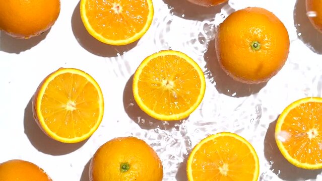 Water dripping on fresh orange slices
