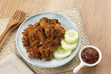 Ayam Goreng Lengkuas, fried chicken cooked with spices and sprinkled with grated galangal. Indonesian traditional food.  
