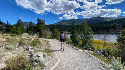 woman hiking trail around Sprague Lake in Rocky Mountain National Park