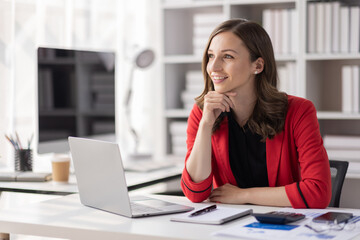 Young latin professional business woman office worker analyst sitting at desk working on laptop thinking on project plan, analyzing marketing or financial data online, Financial and Accounting concept