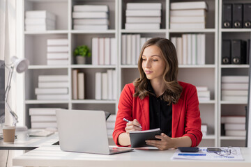 Young latin professional business woman office worker analyst sitting at desk working on laptop thinking on project plan, analyzing marketing or financial data online, Financial and Accounting concept