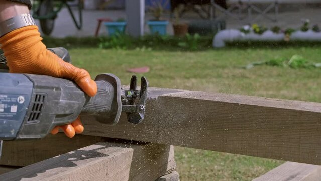 4k footage of a log being cut with a reciprocating Saw