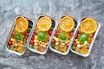 Fruitcake in aluminium foil with white background