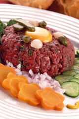 Steak Tartare with ground raw meat, pikles, onion and egg