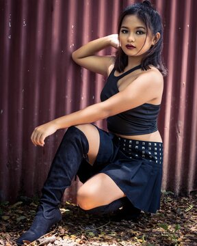 Vertical shot of a philippine teenage girl wearing a skirt and posing