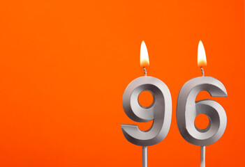 Number 96 - Silver Anniversary candle on orange background