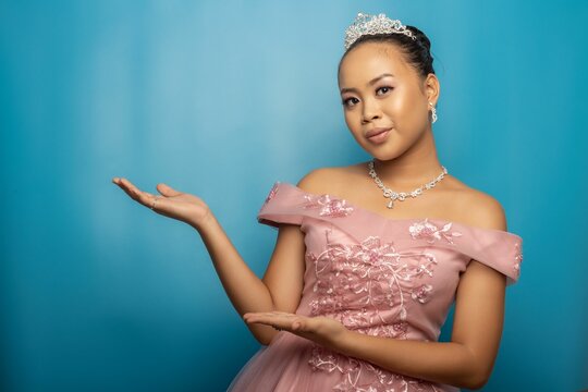 Philippine princess girl marketing a cell phone with a green screen against a blue background - Powered by Adobe