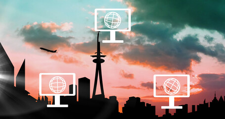 Composition of light trails over computer and globe icons and cityscape