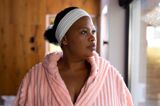 Plus Size African American Woman Wearing Robe And Headband At Health Spa