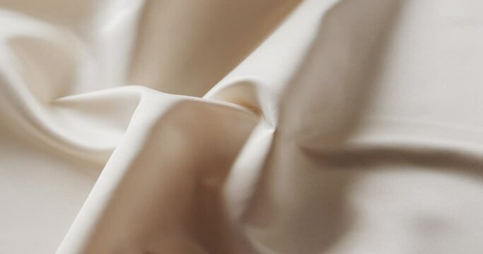Close up of white shiny silk cloth in slow motion