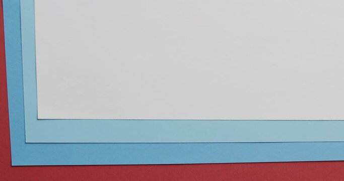 Close up of blank and blue cards on red background with copy space in slow motion