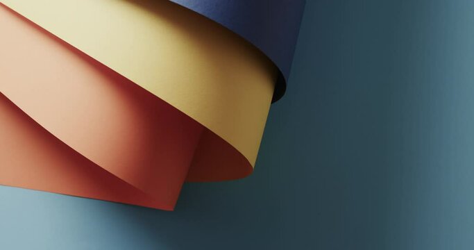 Close up of colourful rolled pieces of paper on blue background with copy space
