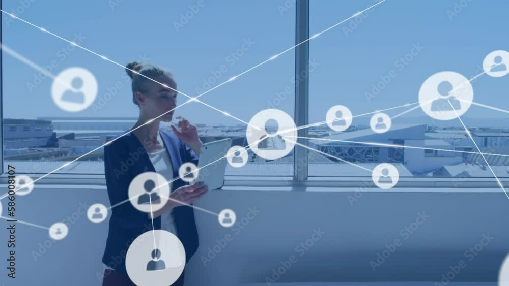 Wall mural Animation of network of profile icons over caucasian businesswoman using digital tablet at office