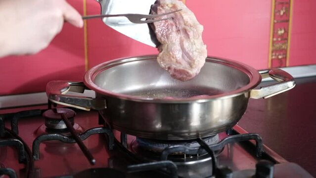 barbecue cutlets look very tasty cooked for a hamburger on a hot open fire on the grill turns over with a spatula after each turn the fire flares up and creates slow motion video for any restaurant.