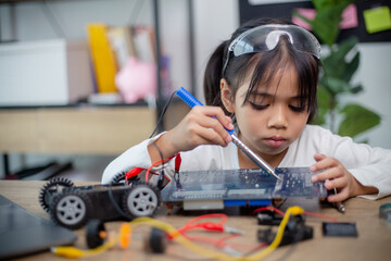 Asia students learn at home in coding robot cars and electronic board cables in STEM, STEAM,