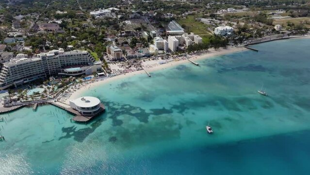 Drone shot around shallow blue sea and tropical beaches of Nassau, sunny Bahamas