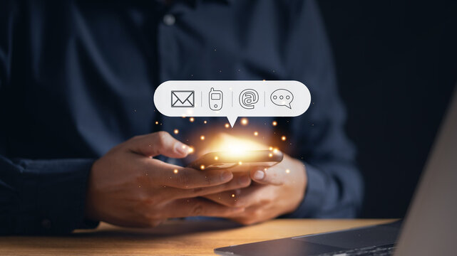 Man using his phone with an email icon, highlighting the importance of digital communication and online connectivity in modern business operations.