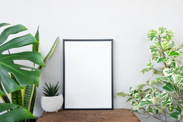 blank frame poster with plant on table