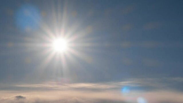 timelapse sunstar in blue sky, clouds moving fast. heavenly air in easter day. cloudy day sky clouds sunbeam rays shine. flying over cloudscap atmosphere, belief in God of Christianity. sunlight bokeh