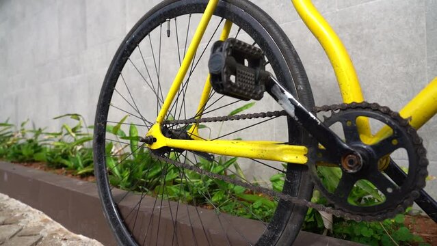City bicycle fixed gear on grey wall. Cycling or commuting in city urban environment, ecological transportation concept.
