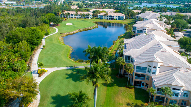 Lake on Golf Course in Gated Community Featuring Luscious Trees Lined with Luxury Real Estate in Naples, Florida