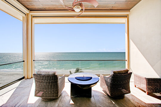 Beach View on Clear Day from Florida Balcony with Outdoor Furniture and Luxury Interiors