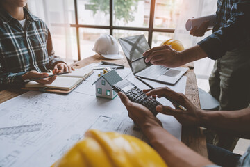 Architectural engineer team meeting house plan writing Housing and work for architectural projects and on-site engineering tools technical construction concept.