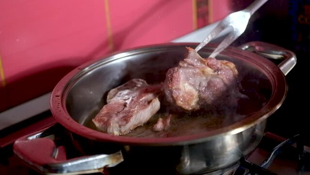barbecue cutlets look very tasty cooked for a hamburger on a hot open fire on the grill turns over with a spatula after each turn the fire flares up and creates slow motion video for any restaurant.