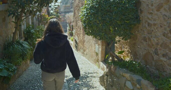 Girl walking down a street full of flowers