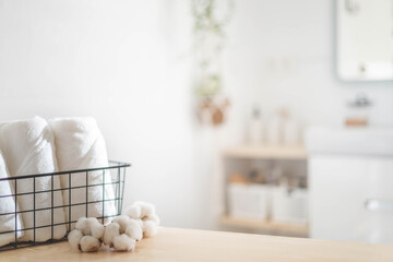 Fototapeta na wymiar Spa white towel rolled in metallic basket cotton flower comfortable hygiene fresh textile bathroom. Blurred background
