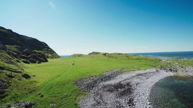 Scenic Nature In Lovund Island Mountains With Hikers During Sunny Day In Nordland, Norway. Wide Shot