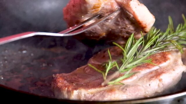 barbecue cutlets look very tasty cooked for a hamburger on a hot open fire on the grill turns over with a spatula after each turn the fire flares up and creates slow motion video for any restaurant.