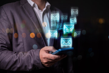 businessman using smart phone sending email on virtual screen, email marketing concept, sending...