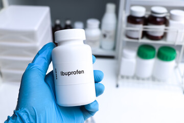 Ibuprofen pill in white bottle, pill stock