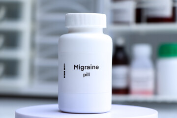 Migraine pill in white bottle, pill stock