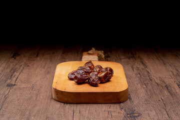 Many Date Palms are on bowls and cups of water and the Quran is on wooden tables, to wait for the time of Iftar, with the concept of ramadan Muslims around the world.